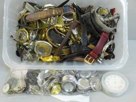 A collection of watch parts including cases, straps, watch backs and movements