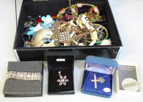 A box of costume jewellery including a silver cross and chain