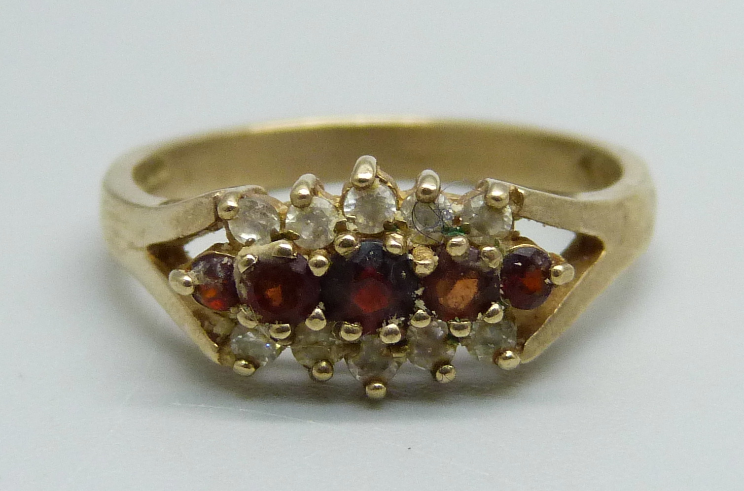 A 9ct gold, white stone and garnet ring, 3.3g, P