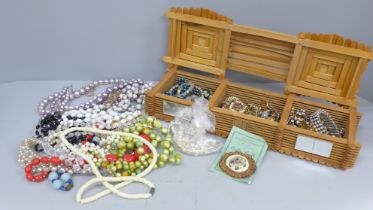 A box and bag of vintage costume jewellery