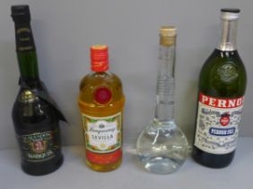 Four bottles; Tanqueray Sevilla, Pernod, Calvados and Grappa **PLEASE NOTE THIS LOT IS NOT