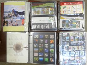 Four albums of stamps, approximately 120 Royal Mail presentation packs, 20 Year packs and Royal