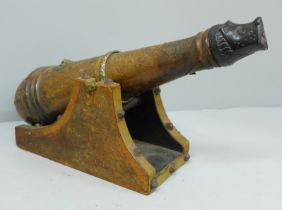 A leather covered wooden decanter in the form of a cannon