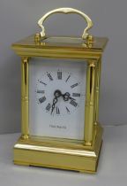 A 20th Century solid brass four glass sided carriage clock, white enamel dial with Roman numerals,