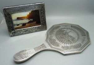 A silver photograph frame, London 1985, 12cm x 16cm, and a hand mirror with engraved detail, Eastern