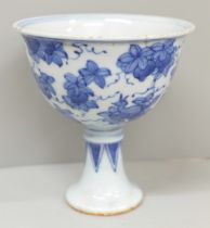 A Chinese blue and white stem cup, four character mark to base, 10cm, a/f, hairline cracks to rim