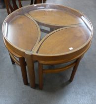 A Nathan Trinity teak and glass topped circular nest of tables