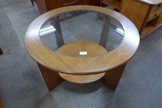 A teak and glass topped circular coffee table