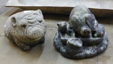 Two concrete garden figures of pigs