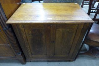 An early 20th Century oak two door cupboard