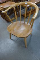 An Ercol Blonde elm and beech 338 model cowhorn fireside chair