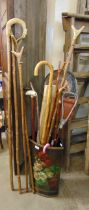 A painted stick stand, with various walking canes, etc.