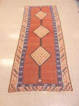 An eastern terracotta ground rug
