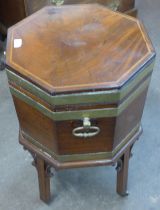 A Regency mahogany and brass bound octagonal wine cooler on stand