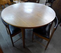 A McIntosh Dunvegan teak circular extending dining table and four chairs, designed by Tom Robertson