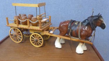 Two porcelain Shire horses with wooden carts