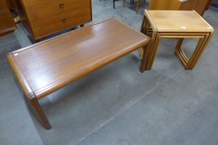 A teak nest of tables and a coffee table