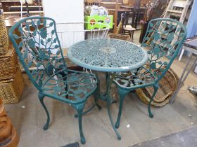 A cast alloy garden table and two chairs