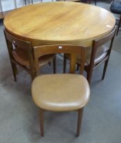 A Nathan teak circular extending dining table and five chairs