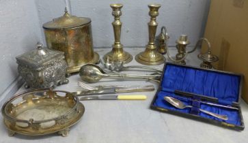 A collection of silver plated items including a Britannia tea caddy, condiment holder, tongs, and