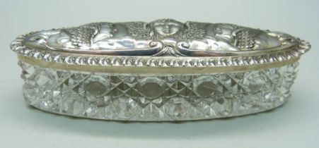 A silver topped dressing table jar decorated with Reynolds angels, Birmingham 1907