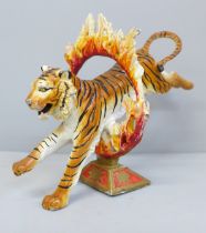 A painted lead model of a circus tiger, 11cm