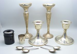 A pair of silver candlesticks, a pair of silver vases, four silver spoons, a/f, an 830 shot and a