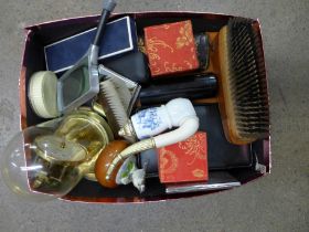A collection of assorted items including a clock, a brush, magnifying glass, paperweight, etc. **