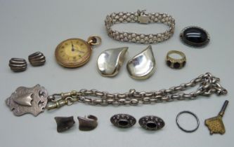 A silver fob on a white metal chain with base metal dog clips, a top-wind fob watch, four pairs of