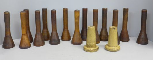 Sixteen 19th Century turned wooden cotton bobbin holders including two ceramic