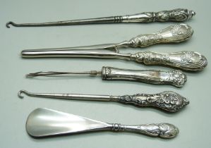 Silver handled tools including one shoe horn decorated with Reynolds Angels