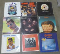 A collection of twenty Queen and Freddie Mercury LP records and 12" singles and a print of Freddie