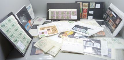 Stamps; a box of stamps on stock cards and in packets