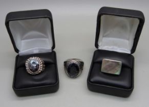 Three silver sings - one set with carved hematite, R, one set with abalone, M, and the other with