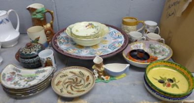 A box of mixed decorative china, Hornsea jug, relief moulded jug, slip ware lidded pot, etc. **