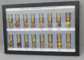 A framed collection of sixteen Allied Victory Medals of WWI miniature medals