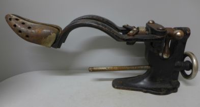 A vintage cast iron cobbler's shoe stretcher