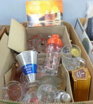 A box of various vintage cocktail glasses, two cocktail shakers, cocktail sticks, one with