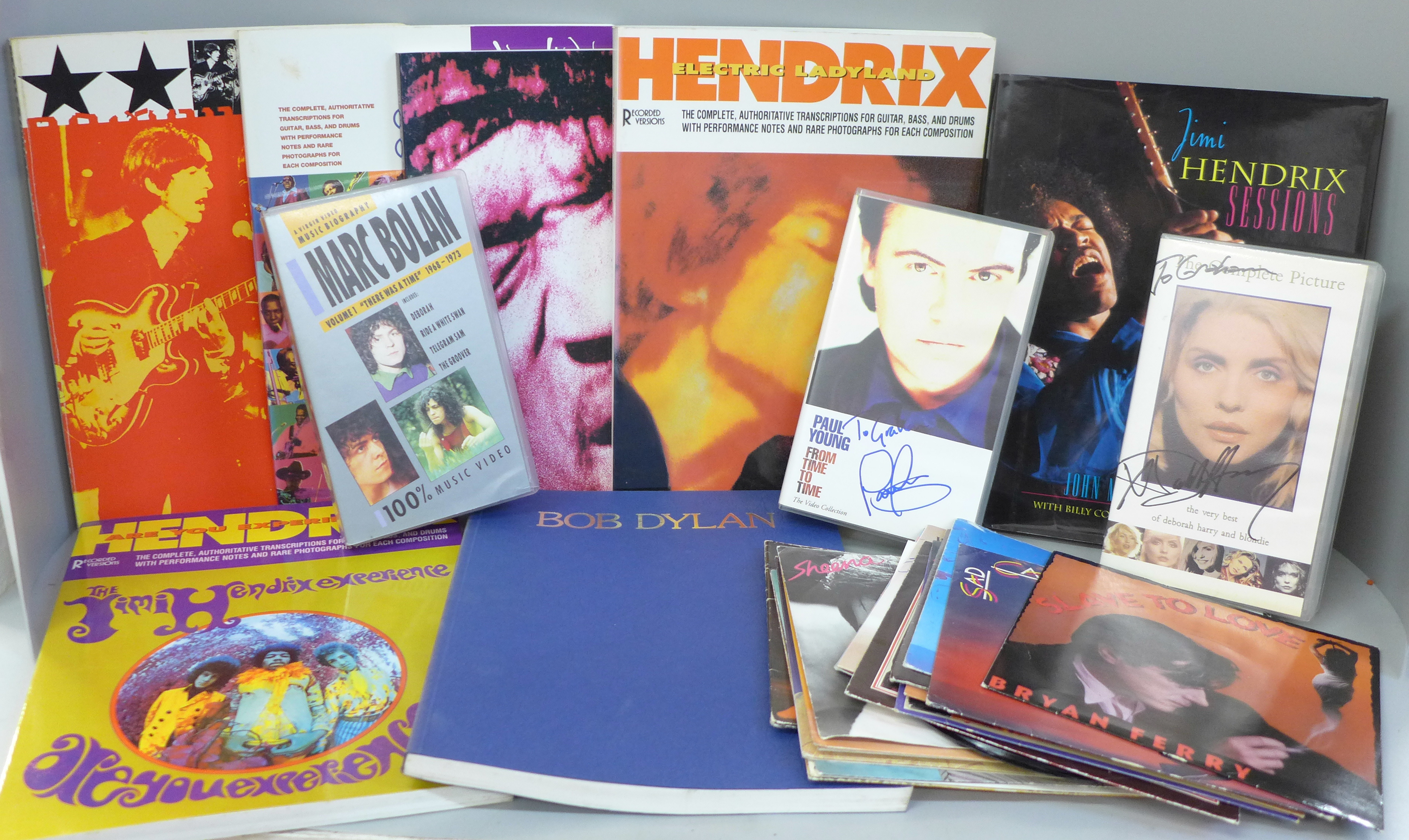 A collection of music tab song books, Jimi Hendrix x4, Bob Dylan and The Beatles, VHS videos