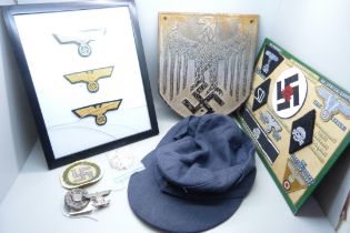 A German WWII metal plaque, cap, mounted cloth badges, etc.