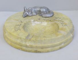 A stone ash tray marked Sicily 1945, with a fox