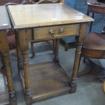 A George III style oak single drawer lamp table