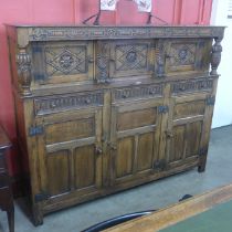 An Elizabethan Revival carved oak court cupboard