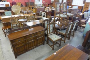 An oak eight piece dining suite, comprising; dining table, six chairs and a sideboard
