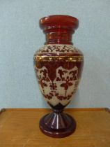 A large etched cranberry glass vase