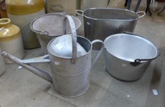 A galvanised bucket, a watering can, a wine cooler and a jam pan