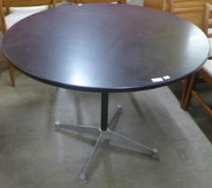 An Eames style aluminium and black lacquered circular dining table