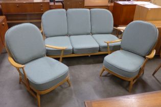 An Ercol Blonde beech Windsor settee and a pair of armchairs, with sage wool fabric cushions