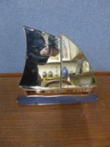 An Art Deco coloured glass yacht shaped strut mirror