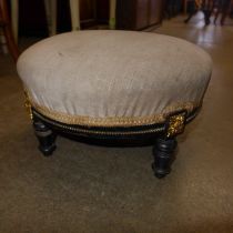 A small Victorian Aesthetic Movement ebonised footstool, made by John Taylor & Sons